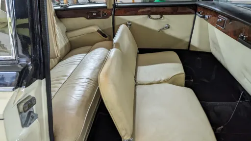 Rear cabin interior with casual seats opened up showing 6 passenger rear seating, Cream leather.
