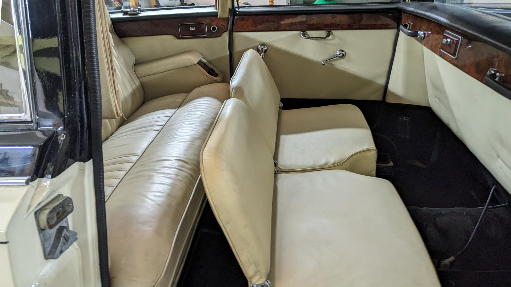 Rear cabin interior with casual seats opened up showing 6 passenger rear seating, Cream leather.