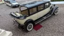 Elevated rear view of black and ivory Bramwith limousine parked on gravel, showing full length and cream interior layout.