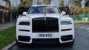 Full view of White rolls-royce Cullinan with large Black and Silver alloy wheels and chrome front grill