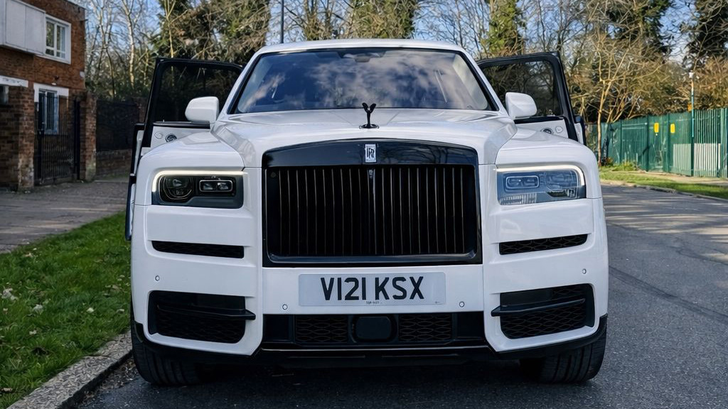 Full view of White rolls-royce Cullinan with large Black and Silver alloy wheels and chrome front grill