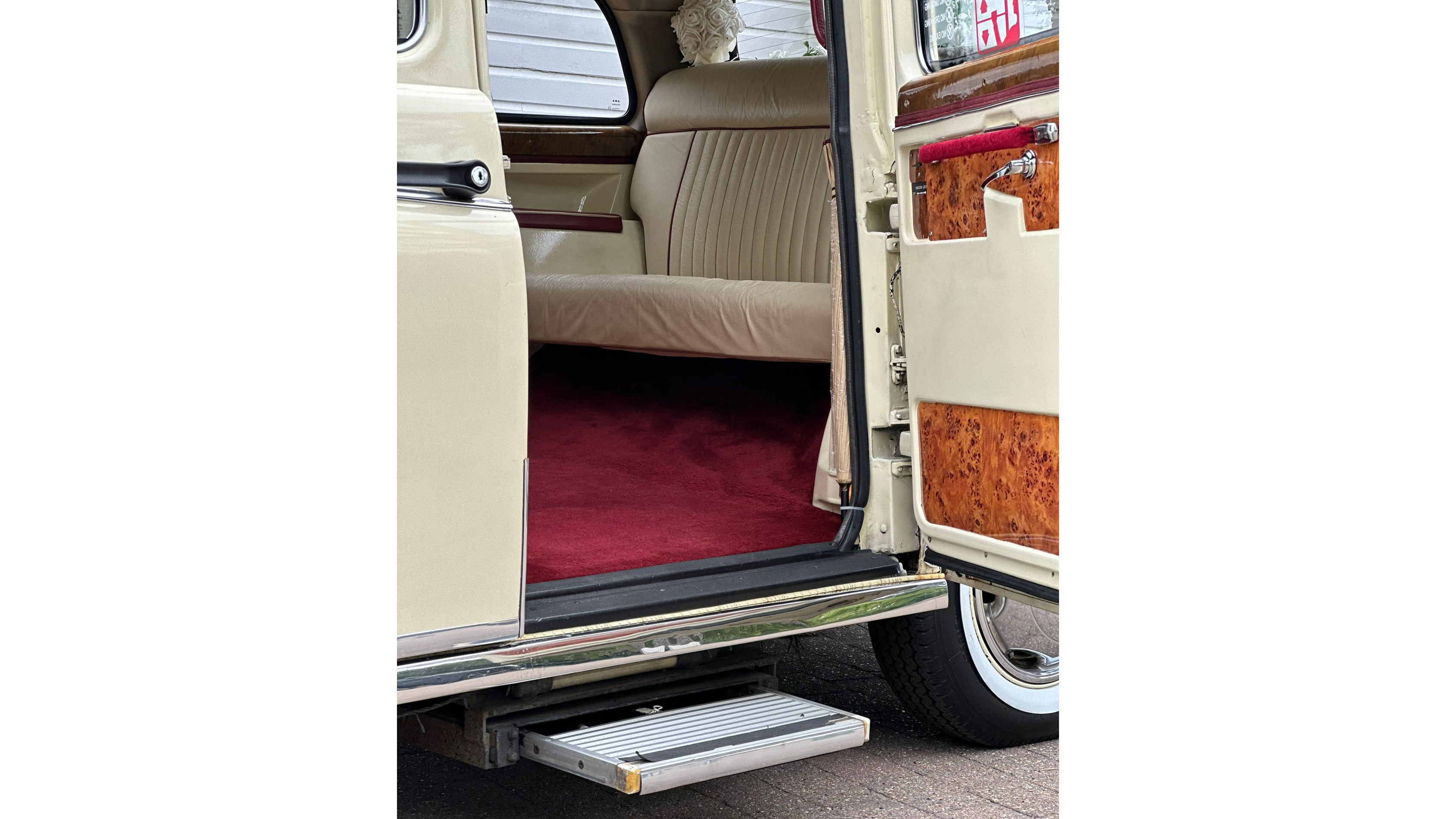 Close view of retractable foot step on classic taxi cab, designed for easy access into the rear cabin.