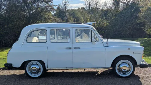 Full right side view of classic Fairway taxi cab in Old English White, showcasing long body and classic design.