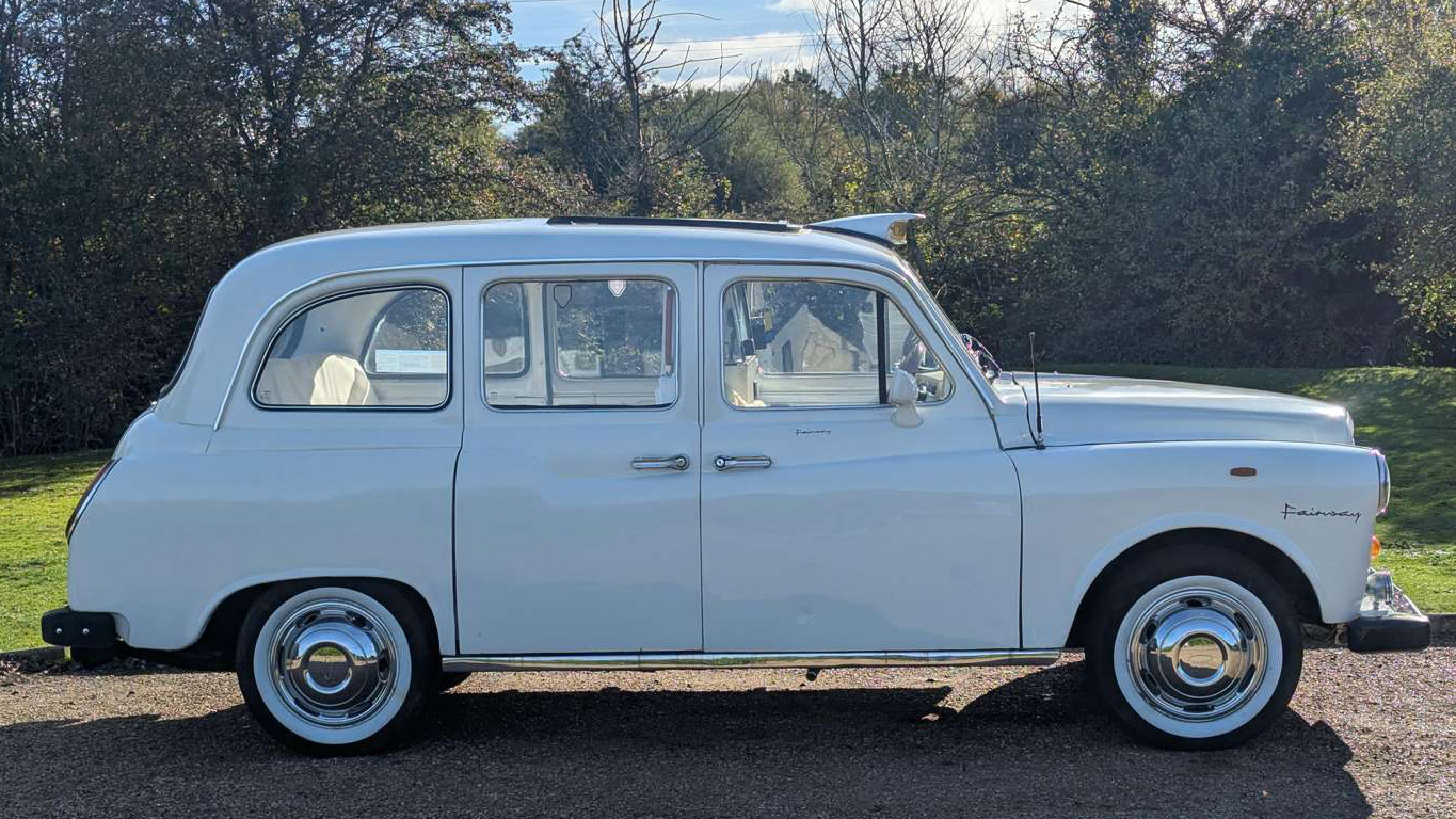 Full right side view of classic Fairway taxi cab in Old English White, showcasing long body and classic design.