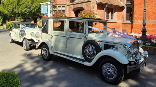 Cream Imperial wedding car driving through Warrington in Cheshire, followed by a Beauford, both decorated for a wedding.
