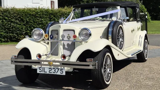 Cream 4 door Beauford wedding car parked in Warrington, Cheshire, with chrome details and classic styling.