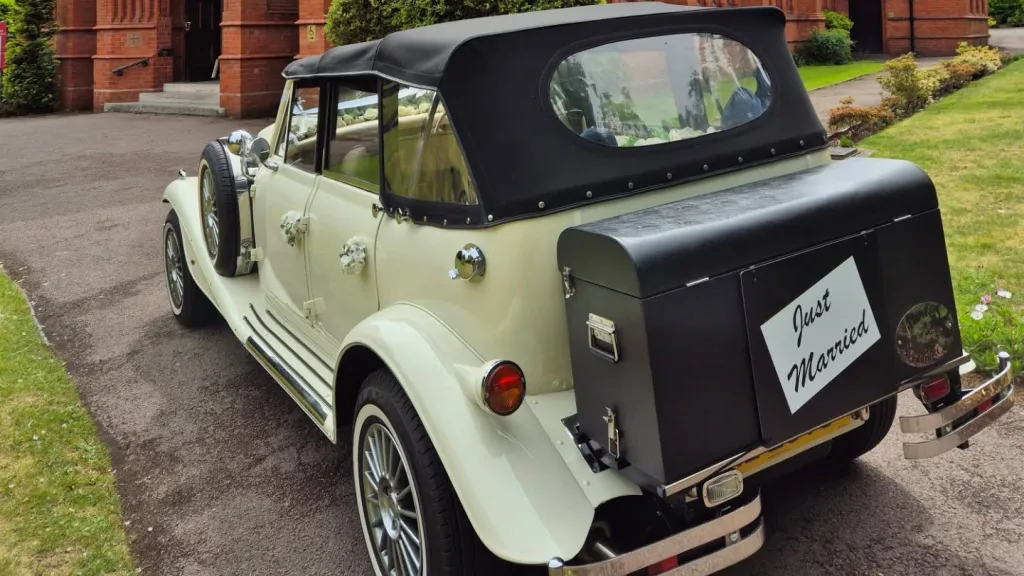 Rear view of cream Beauford showing black picnic trunk and just married sign attached.