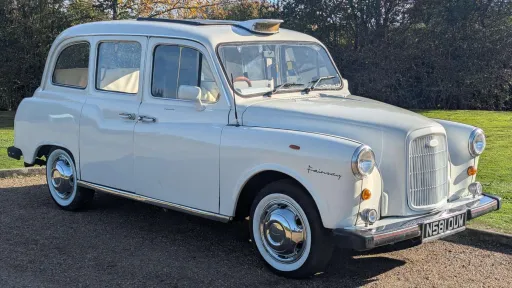 Classic Fairway taxi cab in Old English White with white wall tyres, available for hire in Devon, front three-quarter view.