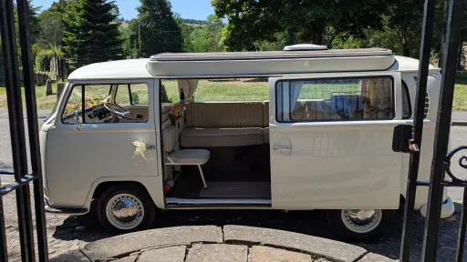 Old English White campervan side view, doors closed, no ribbons, parked outside wedding venue in Chesterfield