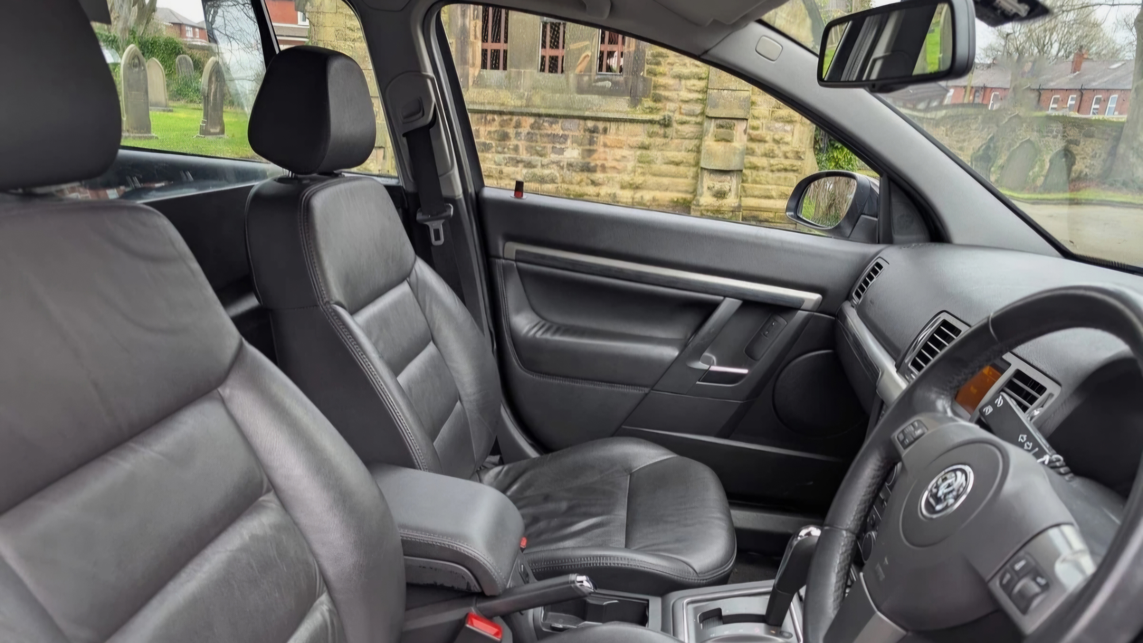 Front passenger seat interior of black stretched Vauxhall Vectra limousine