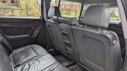 Rear forward-facing black leather seats in stretched Vauxhall Vectra limousine