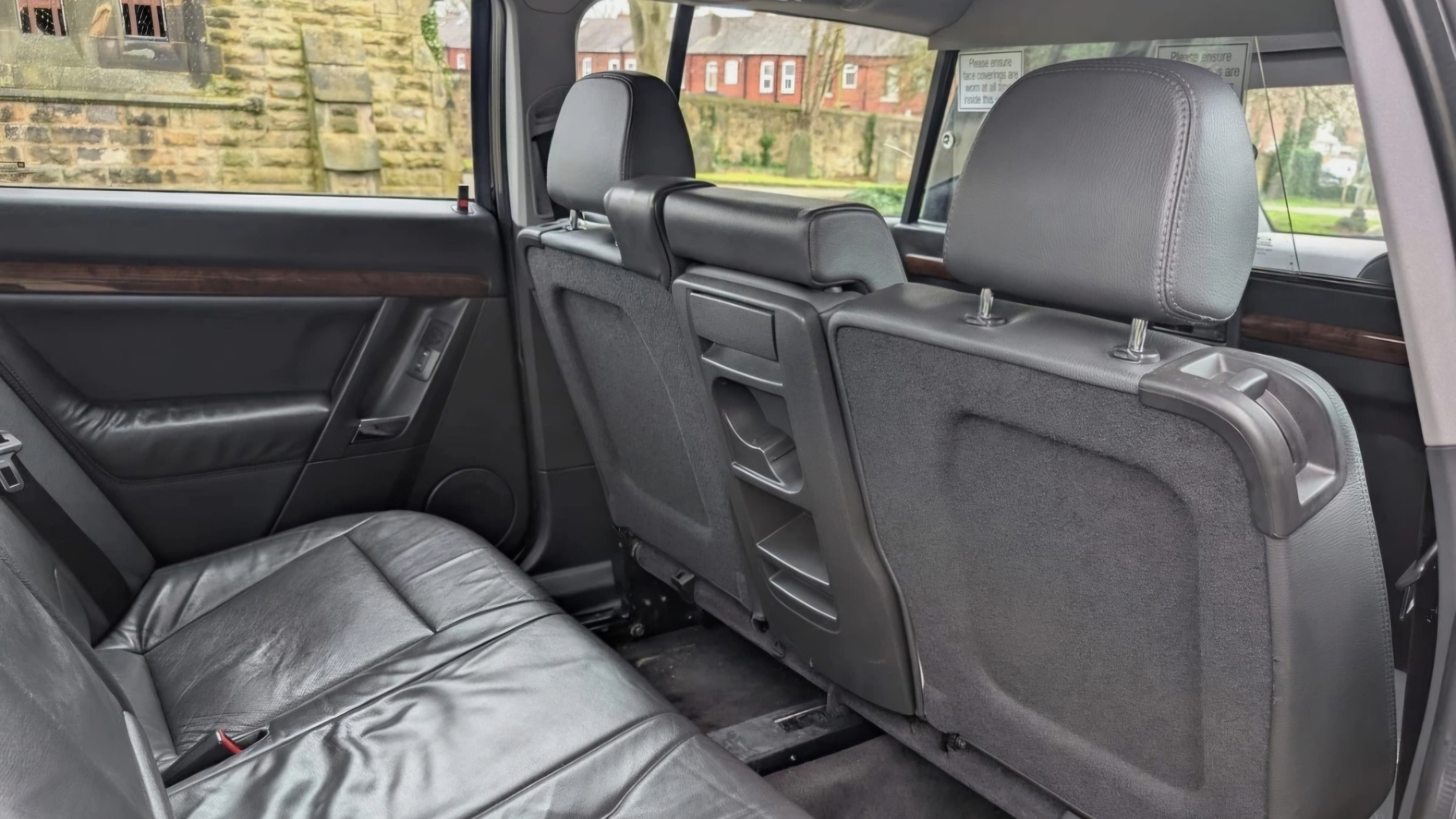 Rear forward-facing black leather seats in stretched Vauxhall Vectra limousine