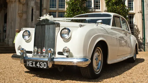 front view classic rolls-royce decorated with wedding ribbons