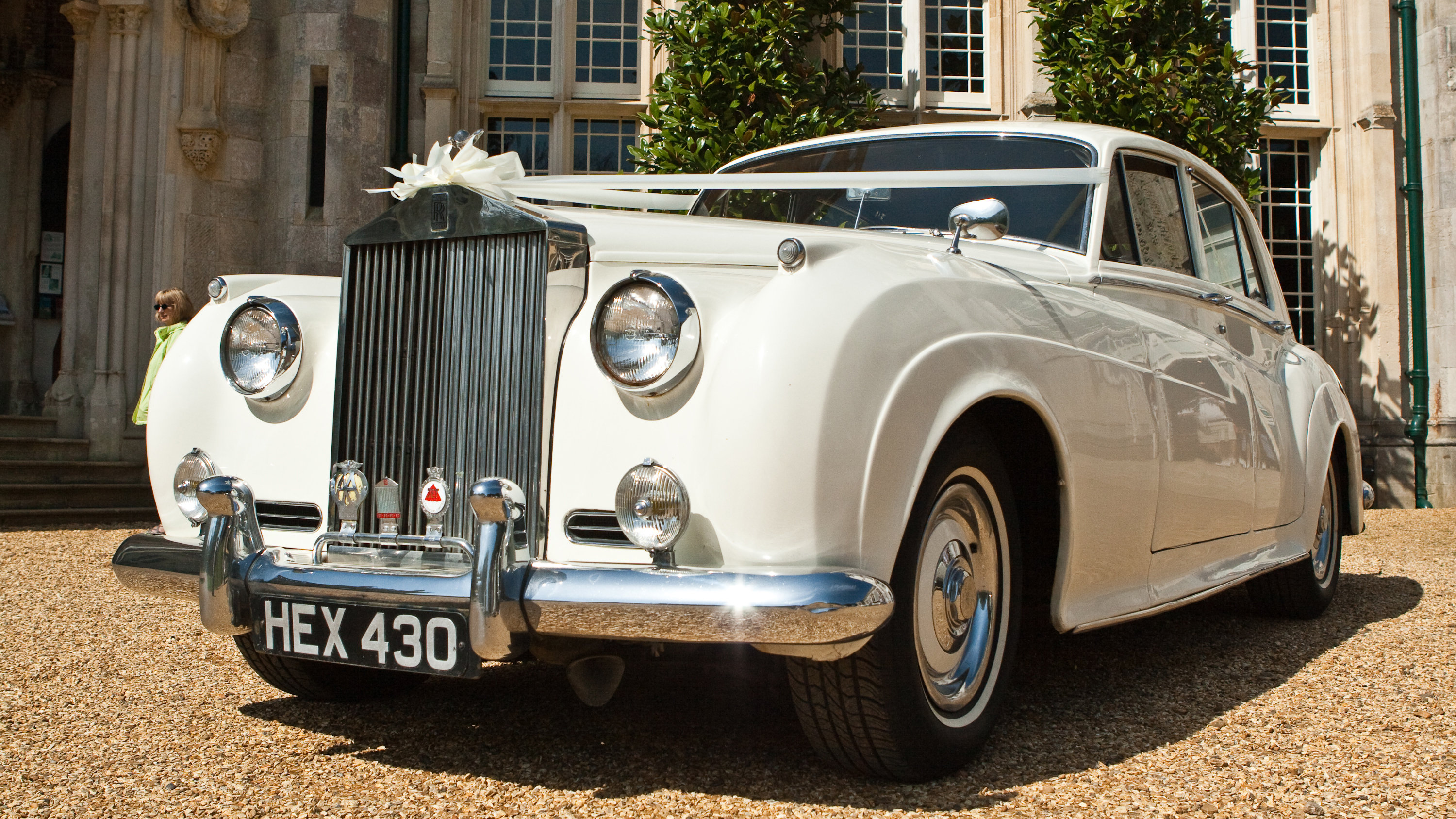 front view classic rolls-royce decorated with wedding ribbons