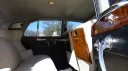 Interior of 1959 Rolls-Royce Silver Cloud showing cream leather seats and polished wood trim