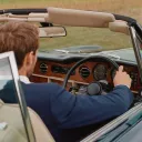 Chauffeur driving a convertible classic car