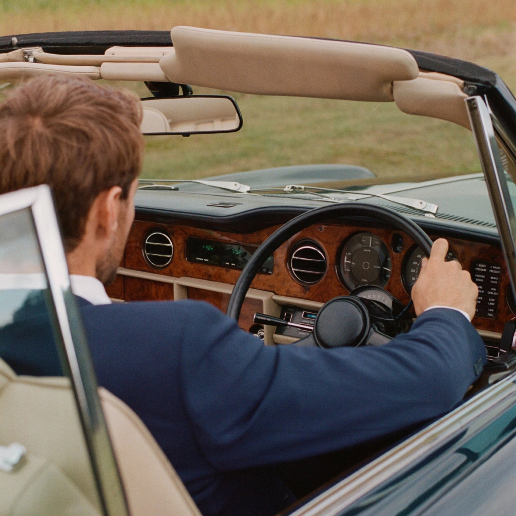 Chauffeur driving a convertible classic car