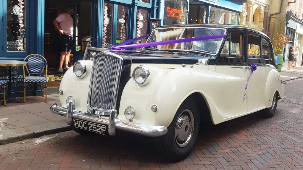 Classic Austin Princess limousine in black and ivory parked in Maidstone town centre for wedding hire.