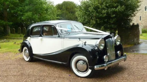 Front side view of Austin Sheerline wedding car in black and Old English White parked outdoors in Kent.