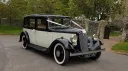 1935 Austin 18 York wedding car in black and ivory parked outside historic venue in Kent with classic whitewall tyres.