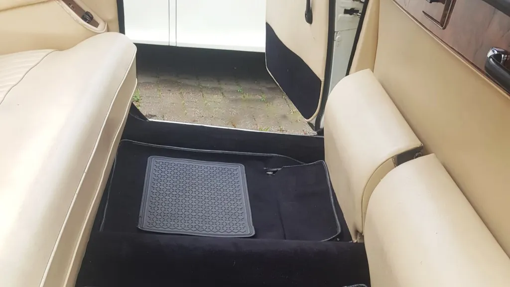 Rear interior of Daimler limousine showing spacious cabin with occasional seats folded down.