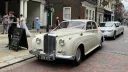 Classic Bentley S1 in Old English White parked on a historic street in Maidstone, Kent, showcasing its polished chrome grille and vintage wedding car elegance.
