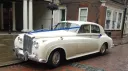 Front left angle view of a Bentley S1 wedding car in Old English White parked in Maidstone, Kent, featuring classic Rolls Royce and Bentley era styling.