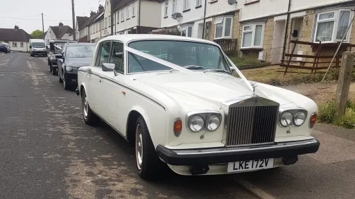 Classic Rolls Royce Silver Shadow in Old English White photographed on a residential street in Kent, showcasing the elegant vintage bodywork and polished chrome front grille.