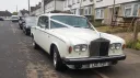 Classic Rolls Royce Silver Shadow in Old English White photographed on a residential street in Kent, showcasing the elegant vintage bodywork and polished chrome front grille.