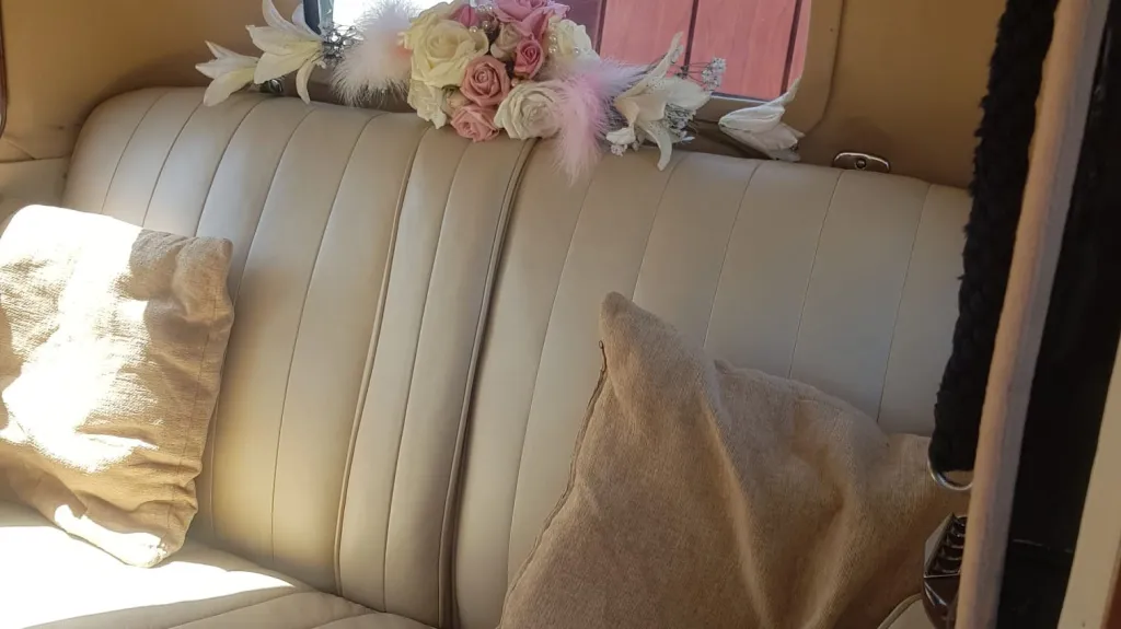 Rear cream leather seating inside 1935 Austin 18 York vintage wedding car with spacious passenger cabin.