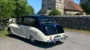 Rear view of classic Austin Princess limousine showing sweeping vintage bodywork and black roof finish.