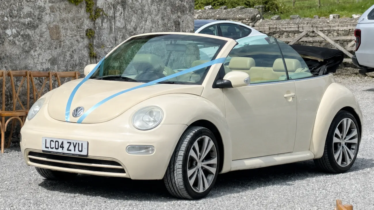 Volkswagen Beetle Convertible decorated with light blue ribbons