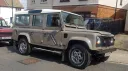 Beige Land Rover Defender wedding car with cream roof parked outside residential property in Kent.