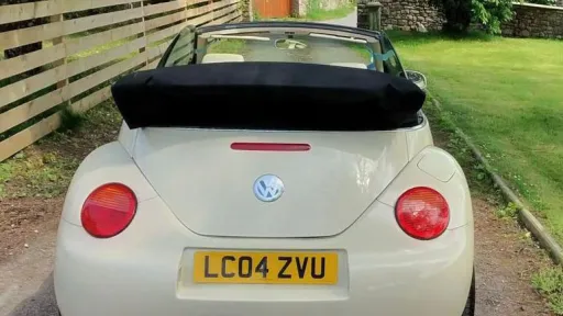 Rear view of a modern VW beetle with convertible soft top roof
