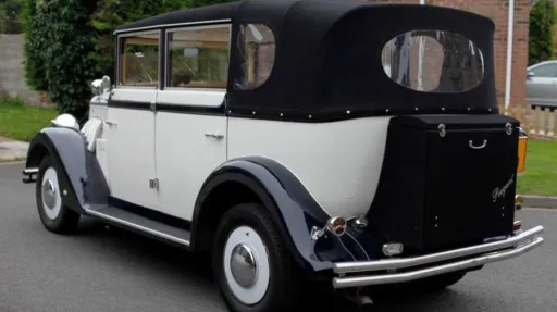 Rear view of Ivory Regent with Black soft top convertible roof closed and rear picnic trunk