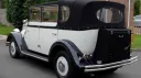 Rear view of Ivory Regent with Black soft top convertible roof closed and rear picnic trunk