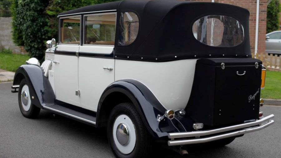 Rear view of Ivory Regent with Black soft top convertible roof closed and rear picnic trunk