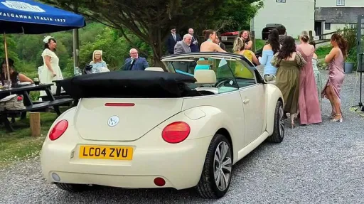 Ivory modern Beetle with wedding guests