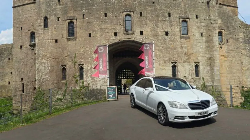 White Mercedes with White wedding ribbons at Welsh wedding venue