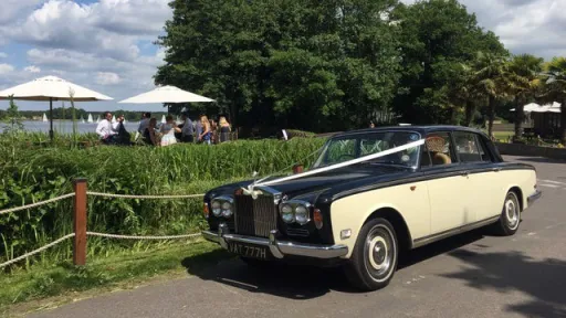 Black and ivory Rolls-Royce Silver Shadow Mark 1 with wedding ribbons, parked outside a Berkshire wedding venue.
