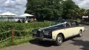 Black and ivory Rolls-Royce Silver Shadow Mark 1 with wedding ribbons, parked outside a Berkshire wedding venue.