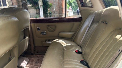 Cream leather rear seats inside a 1970 Rolls-Royce Silver Shadow Mark 1 wedding car.