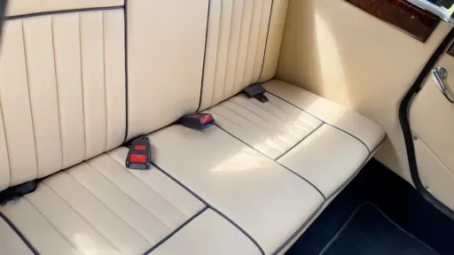 Rear cream leather bench seating inside classic Beauford convertible wedding car.