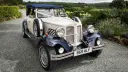 Ivory and navy Beauford convertible wedding car parked in Maidstone, Kent with chrome detailing.