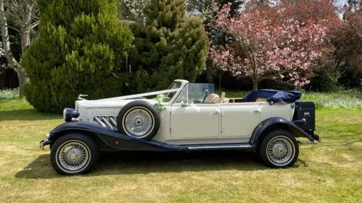 Side profile of Beauford convertible wedding car with navy soft top roof closed.