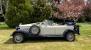 Side profile of Beauford convertible wedding car with navy soft top roof closed.