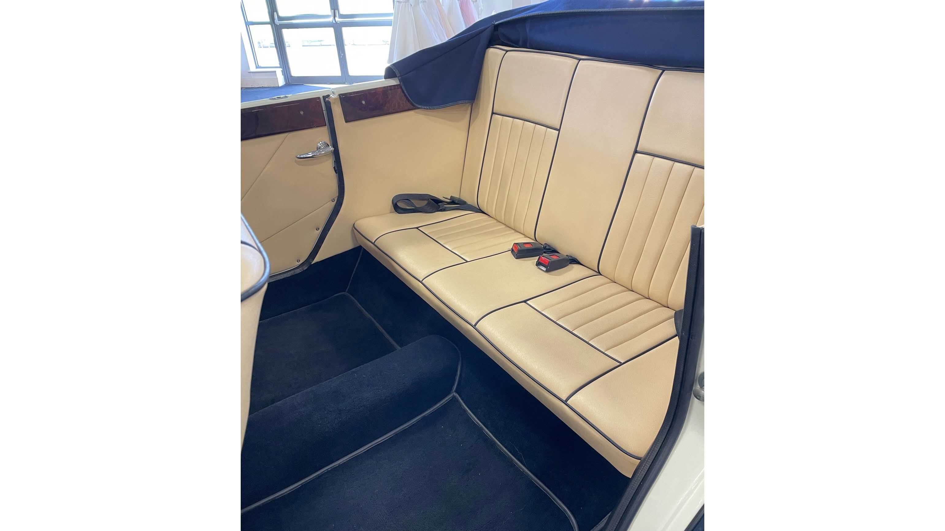 Spacious rear passenger legroom inside Beauford convertible with cream leather interior.