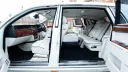 Rear passenger cabin inside Rolls-Royce Phantom Series II EWB showing extended legroom and white leather interior.