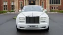 Front view of white Rolls-Royce Phantom Series II EWB with signature chrome grille and Spirit of Ecstasy.