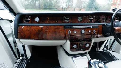 Luxury walnut dashboard and centre console inside Rolls-Royce Phantom Series II EWB.